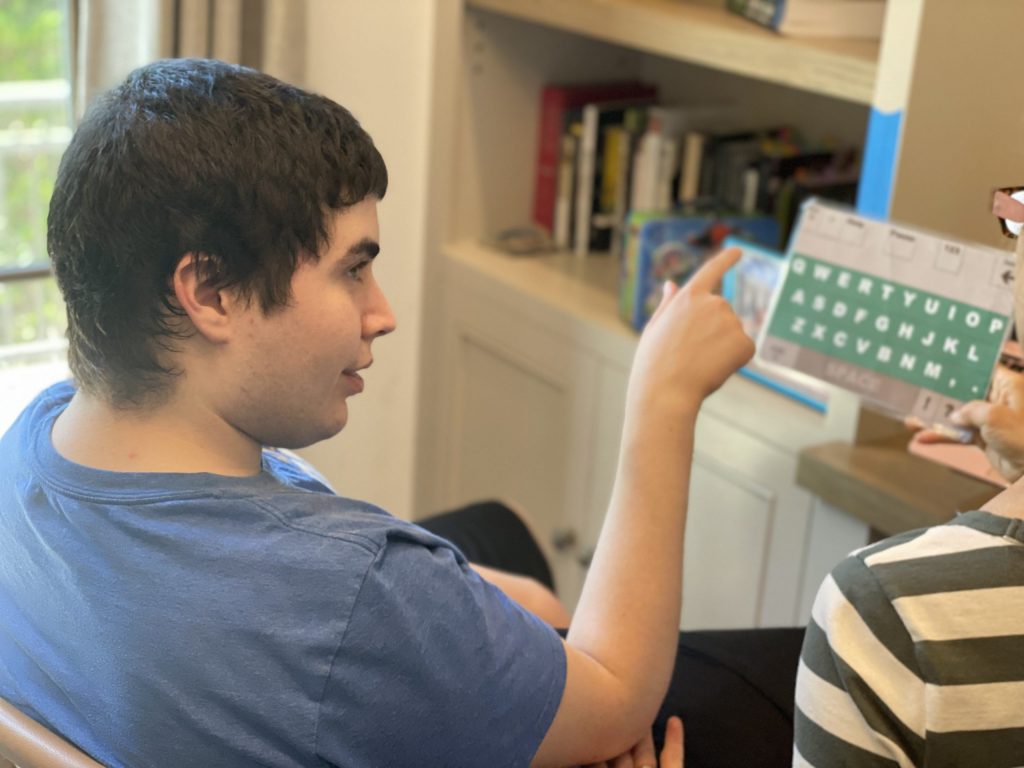 Woody Brown demonstrates how he communicates via letter board