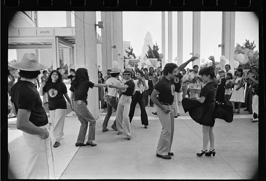 Couples dance in a black-and-white photo