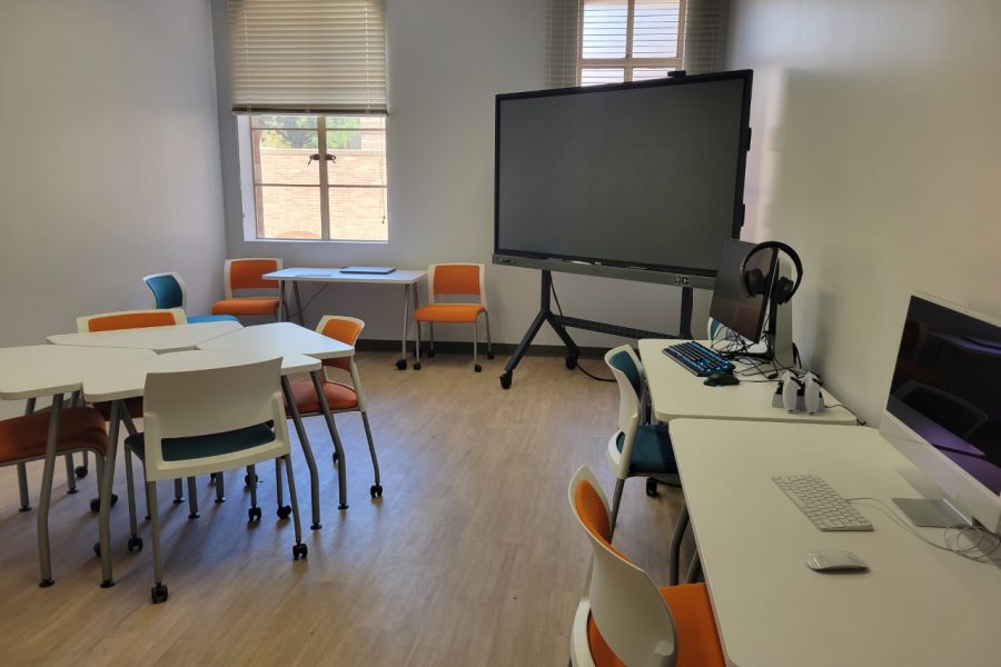 The new Digital Media Lab, a small room with a few tables and chairs, as well as a large screen in one corner