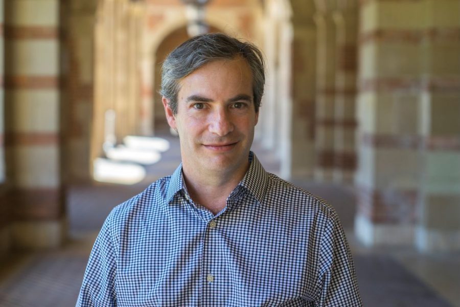 Michael Rothberg poses for a portrait under the arches of Royce Hall.