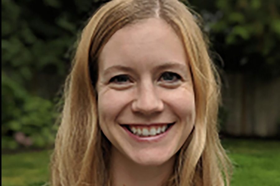 Sarah Beckman smiles against an outdoor backdrop