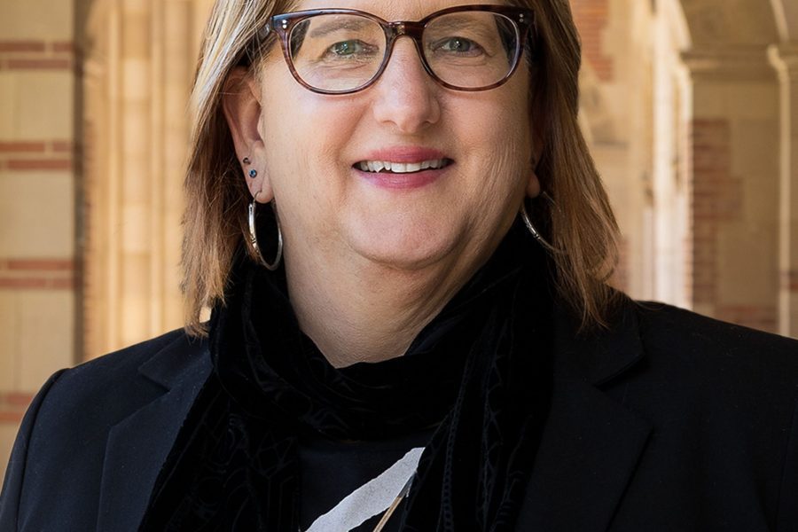 Alexandra Minna Stern smiles under the arches of Royce Hall.