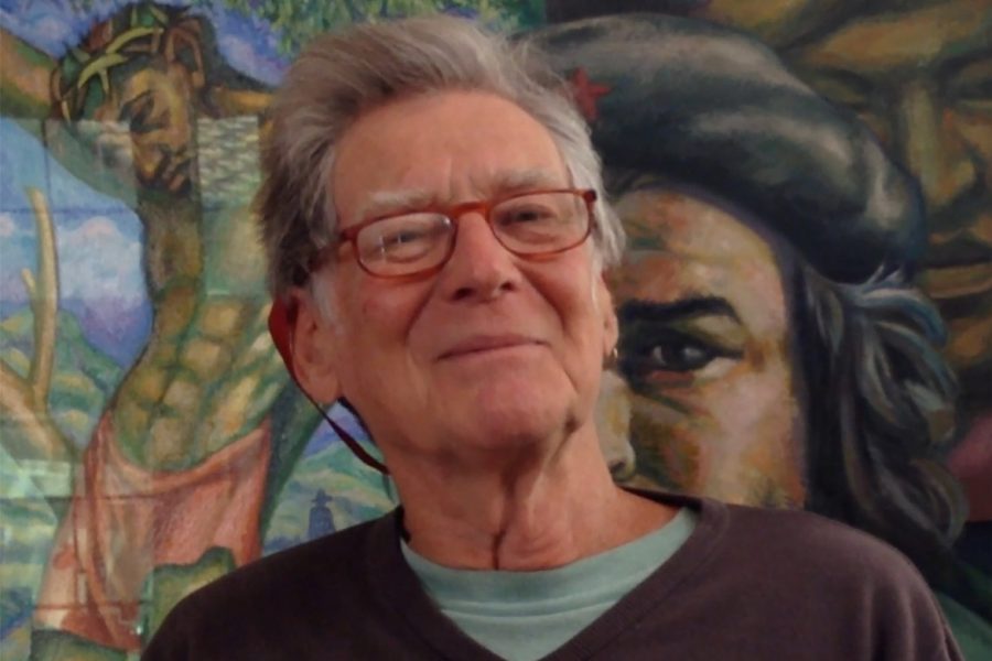 David Kunzle iin front of a mural