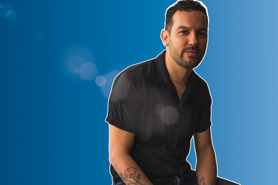 Justin Torres portrait with blue background