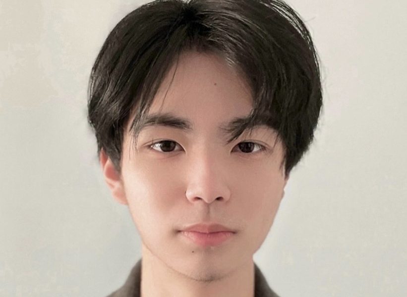 Portrait of Harry Li against a beige background