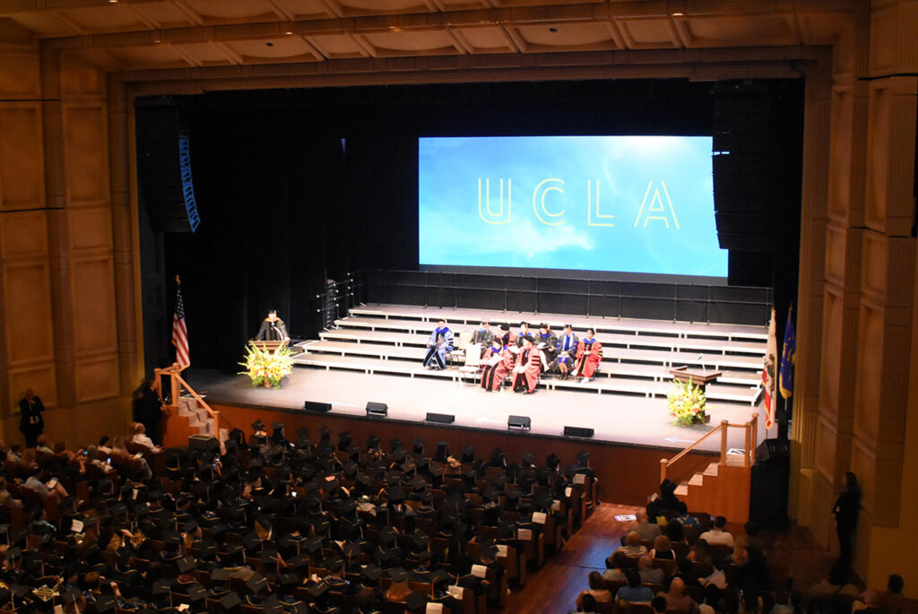 View from balcony of Royce Hall audience and stage during 2024 Humanities commencement ceremony