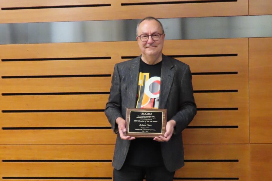 Robert Gore holding the Librarian of the Year plaque