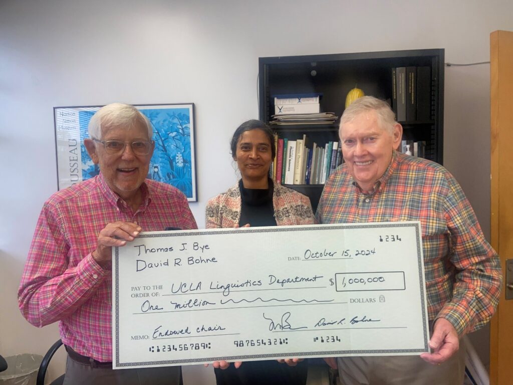 Tom Bye, Professor Megha Sundara and David Bohne with an oversized check representing the gift from Bye and Bohne