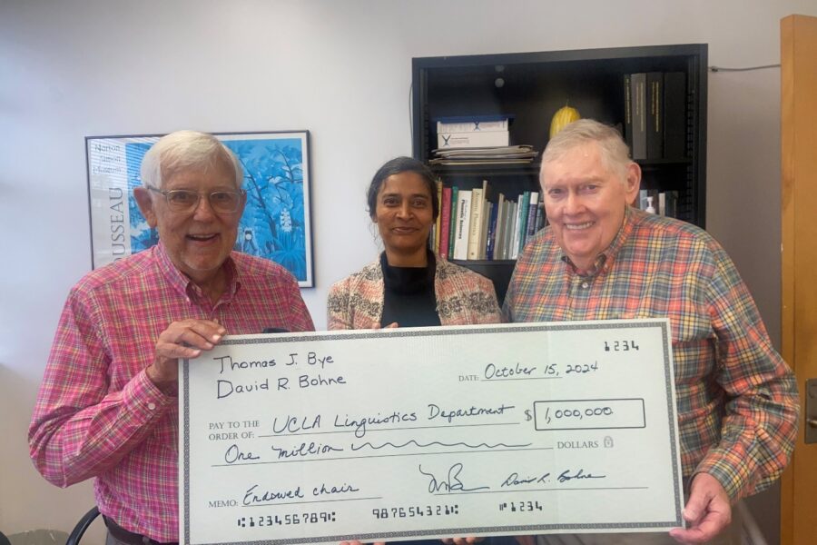Tom Bye, Professor Megha Sundara and David Bohne with an oversized check representing the gift from Bye and Bohne