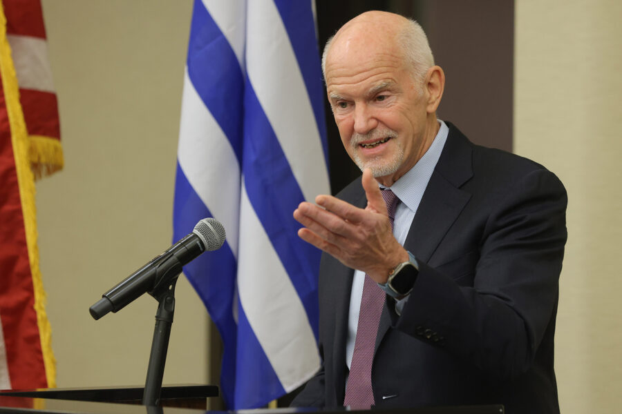Former Greek prime minister George Papandreou speaking at UCLA. Greek flag and U.S. flag are behind him