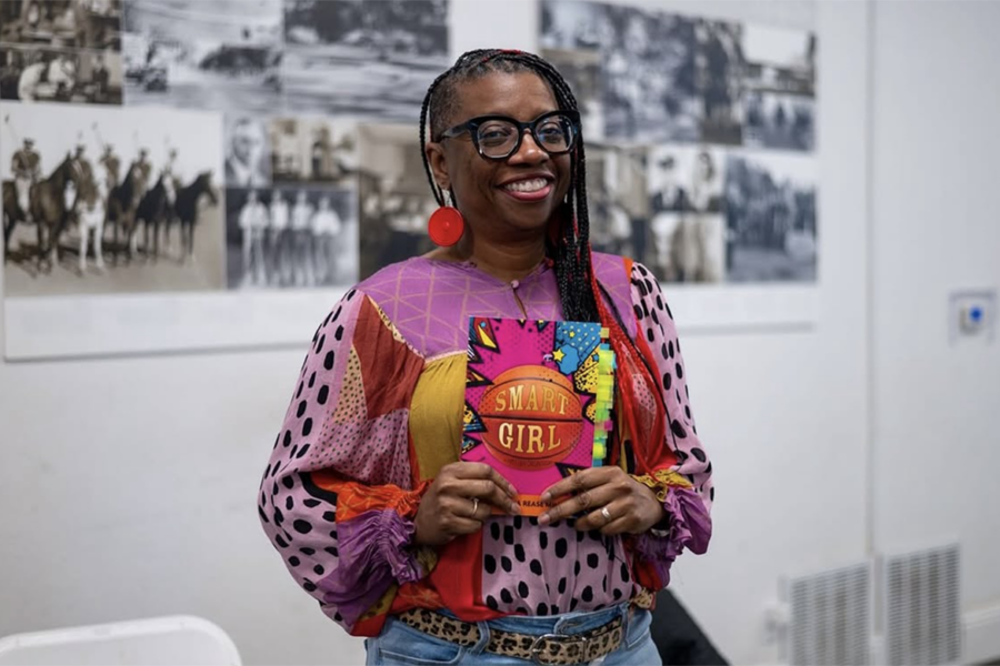 La’Tonya Rease Miles holding a copy of her book