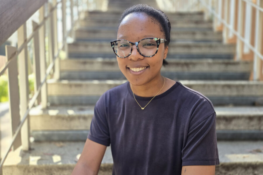 Leila Chiddick seated on steps outside UCLA Broad Art Center