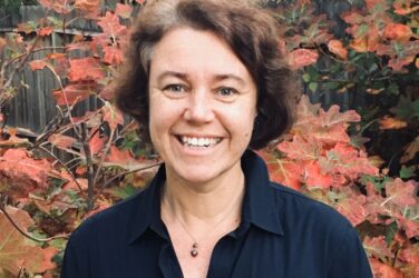 Barbara Fuchs outdoors with flowers in background