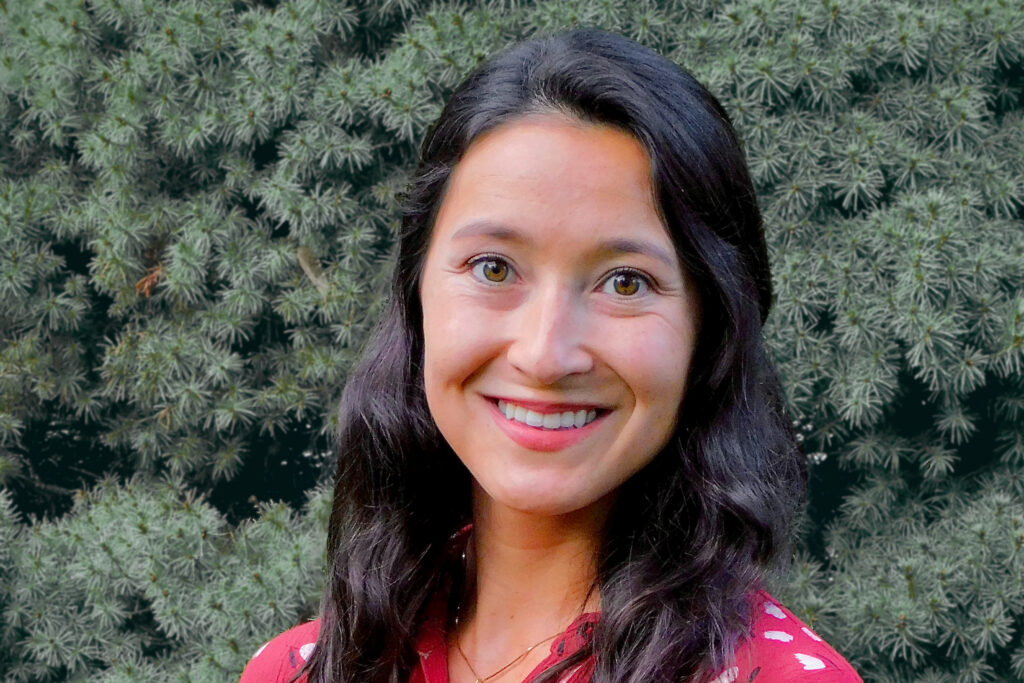 Jennifer Noji with evergreen trees in background