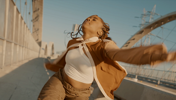 Woman dancing on 6th Street bridge, still from AIre Libre film