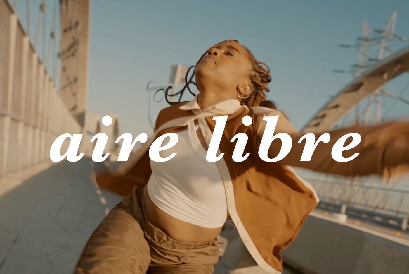 TItle image for Aire Libre film with woman dancing bridge and "Aire Libre" text