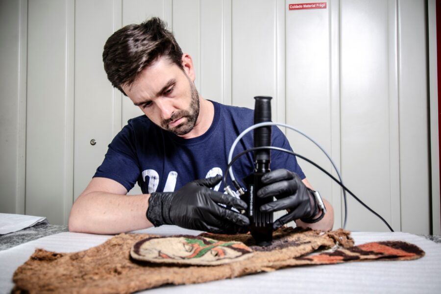 Thiago Puglieri analisa uma máscara do Museu de Arqueologia e Etnologia da Universidade de São Paulo