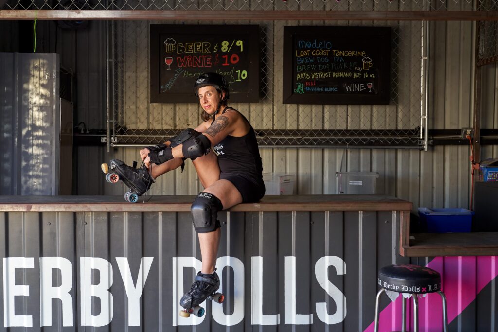 Marissa Lopez lacing up roller skates sitting on countertop