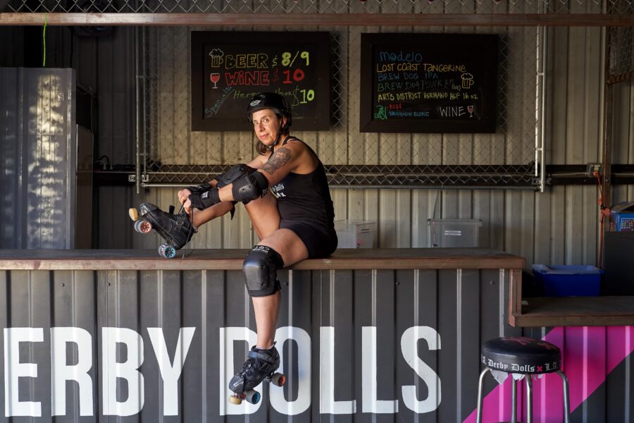 Marissa Lopez lacing up roller skates sitting on countertop